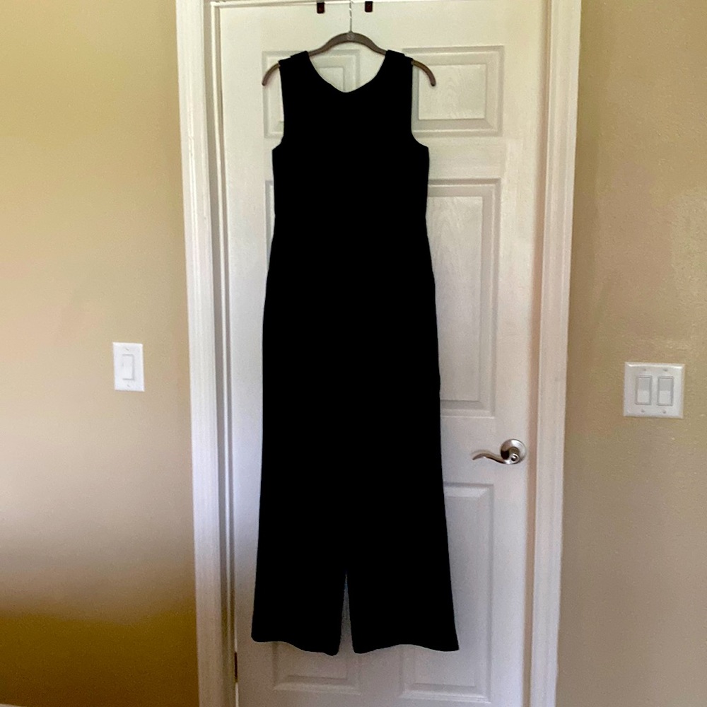Black jumpsuit, full body, front and back with rounded collar.